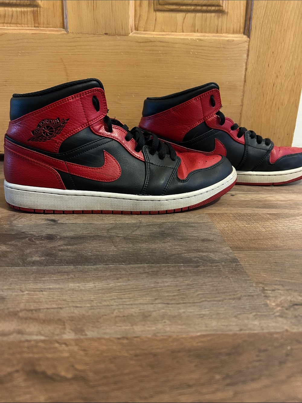 Jordan 1 Retro High Top Sneakers in Black and Red